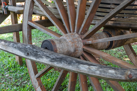 Close up old wheel of cartwheel made from hardwood.の写真素材