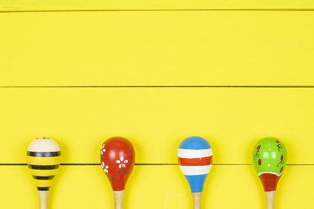 Colorful maracas  on yellow wooden boards background.の写真素材