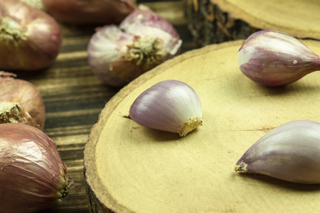 Close up of shallots on wooden table background.