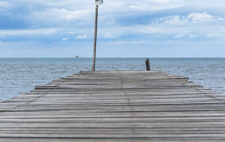 Wooden pathway end of the sea and blue sky background