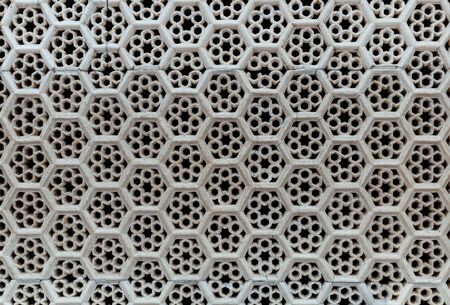 White color ventilated bricks wall background and texture.