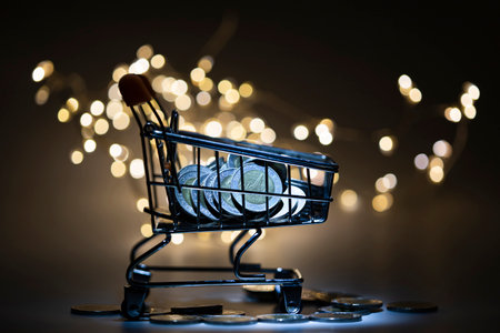 A lot of coin( Thai Baht) in shopping cart with light and blurred bokeh background.の写真素材