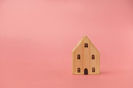A model house placed on a pink colored background.の写真素材