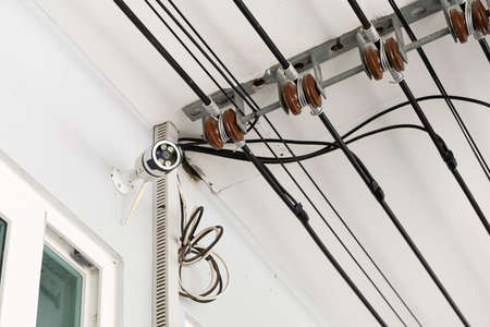 CCTV mounted on the front wall of house. And main cable for power supply.