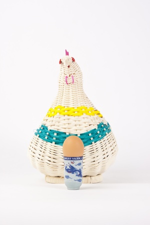The egg in hen basket isolated on white backgroundの写真素材