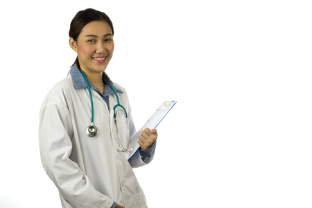 Asian young female doctor smiling at camera isolated on white backgroundの写真素材