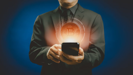 Businessman choosing virtual hologram bitcoin crypto currency stock from smartphone with blockchain technology, electronic money investment in digital asset market, trading commercial in future globalの写真素材