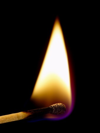 Burning match on a black background