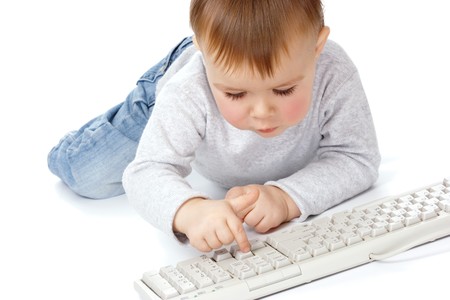 Cute child typing on a keyboard, isolated over whiteの写真素材
