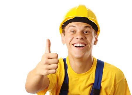 Young cheerful construction worker showing thumb up sign, isolated over whiteの写真素材