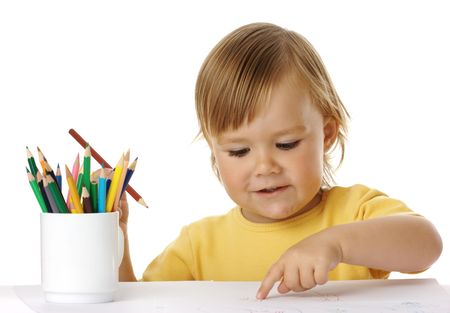 Cute child points on his drawing, isolated over whiteの写真素材