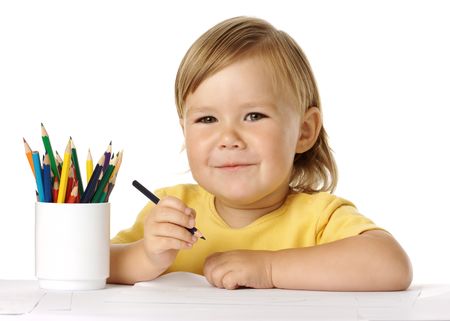 Happy child draw with crayons, isolated over whiteの写真素材