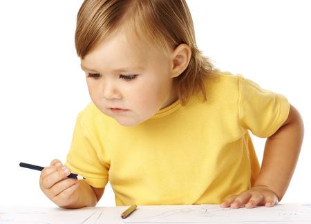 Cute child half-rise from table, playing with crayons, isolated over whiteの写真素材