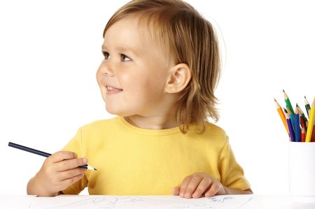Happy child draw with color crayons and smile, isolated over whiteの写真素材