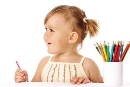 Happy child play with colorful crayons and smile, isolated over whiteの写真素材