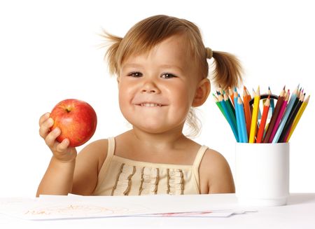 Happy child in preschool, play with color pencils and smile, isolated over whiteの写真素材