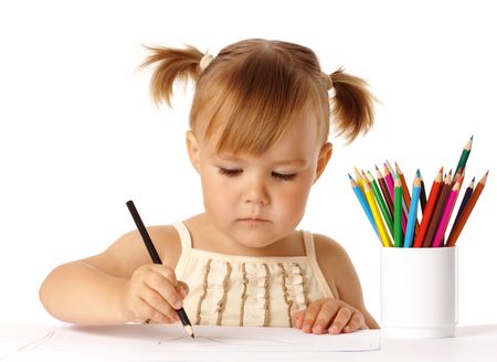 Cute preschooler focused on drawing, isolated over whiteの写真素材
