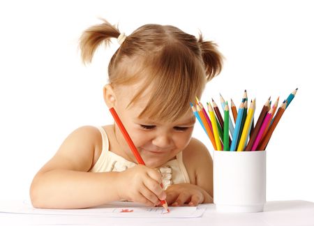 Happy child play with color pencils and smile, isolated over whiteの写真素材