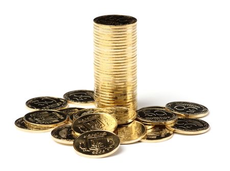 Stack of golden coins, isolated over whiteの写真素材
