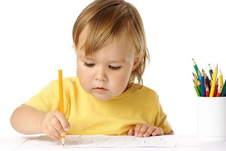 Preschooler focused on her drawing, isolated over whiteの写真素材