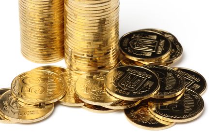 Closeup of a golden coins, isolated over whiteの写真素材