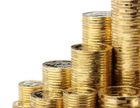 Closeup of golden coins arranged in stacks, isolated over whiteの写真素材
