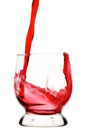 Splash - red wine is being poured into glass, isolated over whiteの写真素材