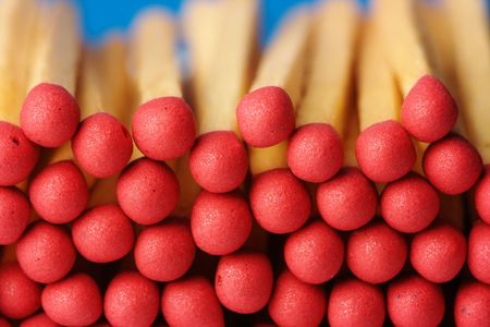Red matchsticks on blue background, shallow DOF