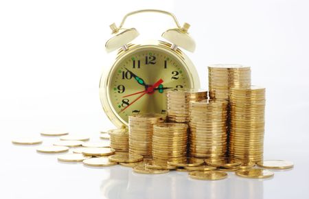 Old-fashioned clock dial on golden coins background, time is money concept, isolated over whiteの写真素材