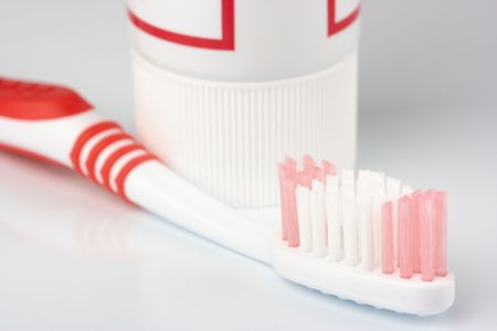 Single toothbrush and toothpaste on white - common toiletriesの写真素材
