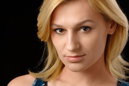 Portrait of a beautiful blonde, isolated over blackの写真素材
