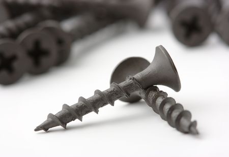 Wood screws on white surface, shallow DOFの写真素材