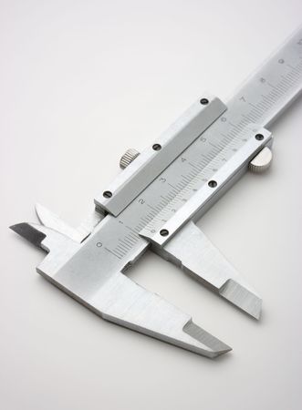 Stainless steel trammel on a white surfaceの写真素材