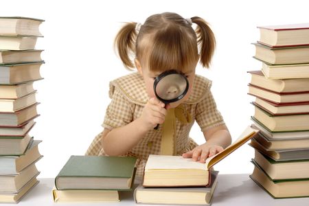 Girl surrounded by books looking at nails using magnifier, isolated over whiteの写真素材