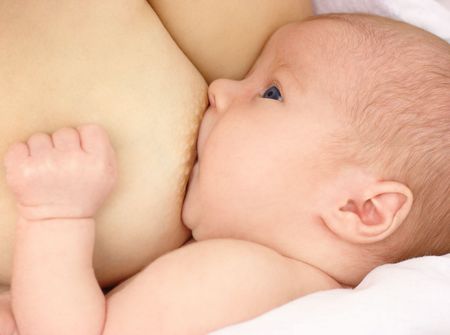 Newborn sucks mother's breast, breastfeeding, shallow DOFの写真素材