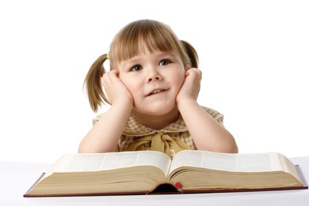 Happy little girl with big book, back to school, isolated over whiteの写真素材