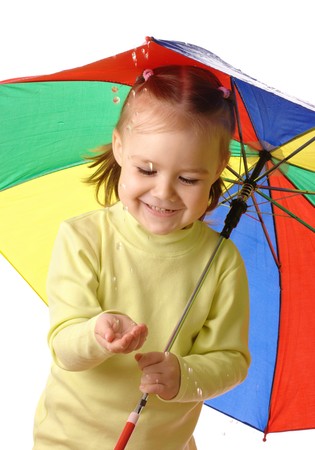 Cute cheerful child with colorful umbrella is catching raindrops, isolated over whiteの写真素材
