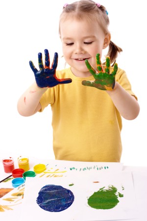 Cute cheerful child paint using hands, isolated over whiteの写真素材