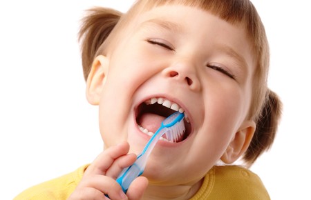 Cute child with toothbrush, isolated over whiteの写真素材