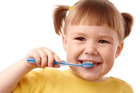 Cute child with toothbrush, isolated over whiteの写真素材