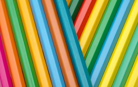 Background made of crayons randomly arranged by colorの写真素材