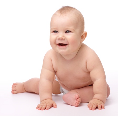 Happy child is sitting on floor, isolated over whiteの写真素材