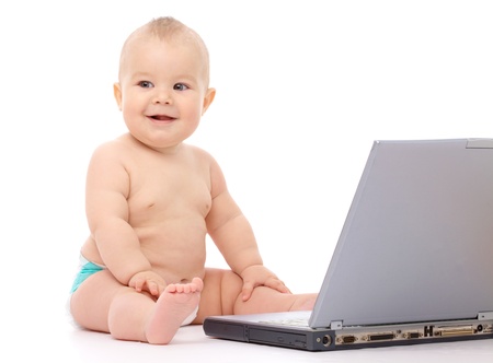 Little baby boy is sitting on floor with his laptop, isolated over whiteの写真素材
