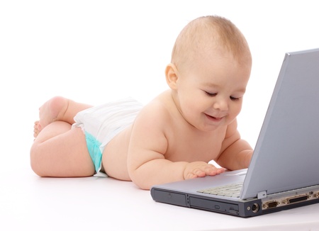 Little baby boy is laying on floor with his laptop, isolated over whiteの写真素材