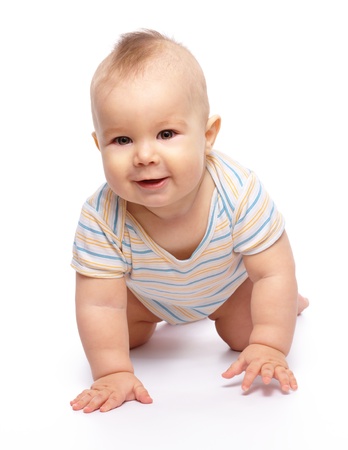 Happy child is crawling on floor and smile, isolated over whiteの写真素材
