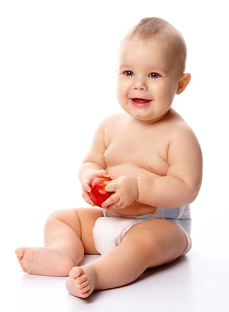Portrait of a cute little child with red apple, isolated over whiteの写真素材