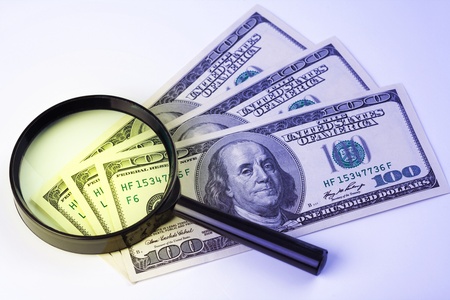 Few hundred dollars under a magnifying glassの写真素材