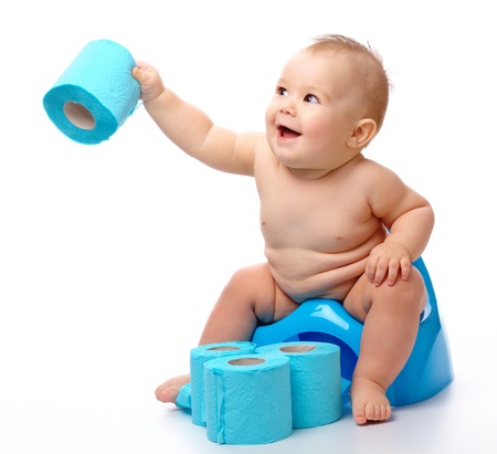 Child on potty play with toilet paper, isolated over whiteの写真素材