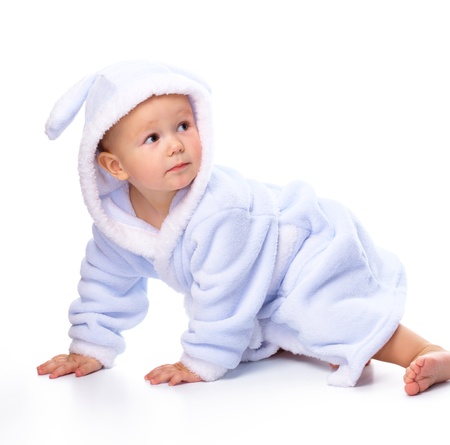 Bright portrait of a cheerful child in blue bathrobe, isolated over whiteの写真素材
