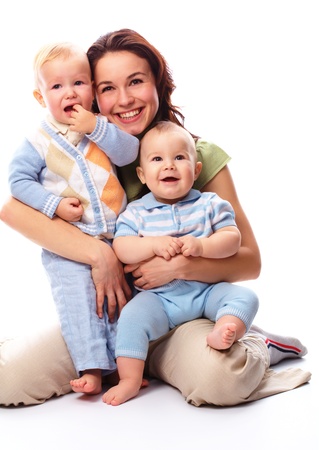 Young happy mother embrace her two boys, isolated over whiteの写真素材